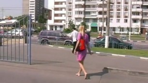 Beautiful blonde walking barefoot in town.