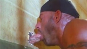 Horny inmate sucks off cock through gloryhole