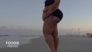 BBW walks and poses on public beach