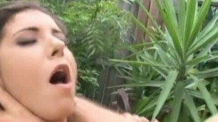 Kinky brunette fucking two cocks in the garden