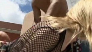 Sexy blonde in black fishnet top gives head and gets fucked by three guys