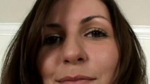 Camera guy films a pretty brunette slut on her knees sucking his hard cock